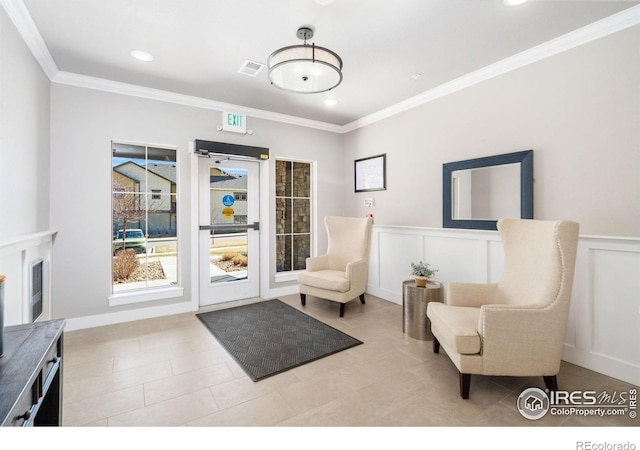 sitting room featuring visible vents, a wainscoted wall, ornamental molding, recessed lighting, and a decorative wall