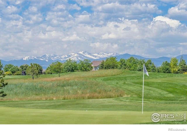 surrounding community featuring view of golf course, a lawn, and a mountain view