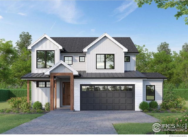modern farmhouse style home featuring decorative driveway, board and batten siding, an attached garage, and a standing seam roof