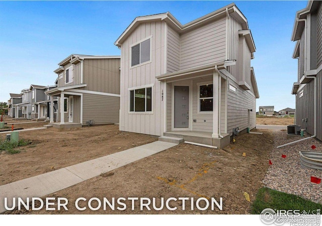 townhome / multi-family property featuring central air condition unit and board and batten siding