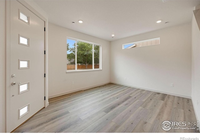 entrance foyer with recessed lighting, baseboards, and light wood-style floors