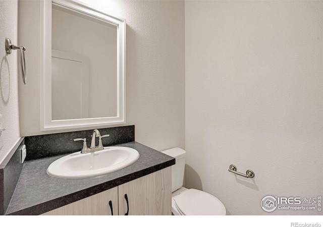 bathroom with toilet and vanity