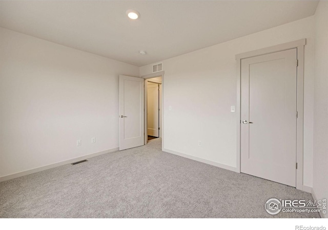 unfurnished bedroom featuring recessed lighting, carpet, visible vents, and baseboards