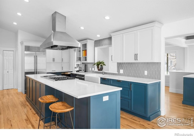 3380 Longwood Ave, Boulder, CO 80305 - kitchen with blue cabinets, a sink, gas cooktop, a kitchen island, and island range hood