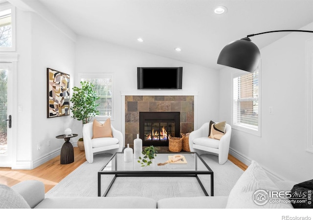 3380 Longwood Ave, Boulder, CO 80305 - living room featuring recessed lighting, lofted ceiling, wood finished floors, and a tiled fireplace