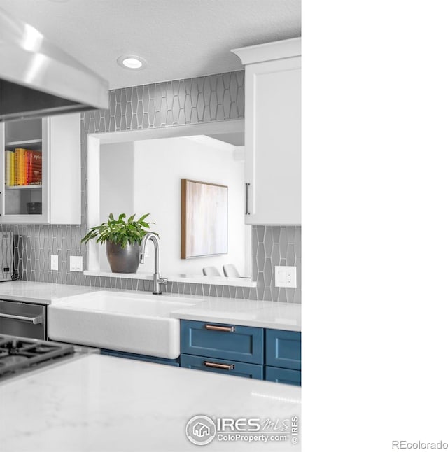 3380 Longwood Ave, Boulder, CO 80305 - kitchen with glass insert cabinets, blue cabinetry, light countertops, and a sink