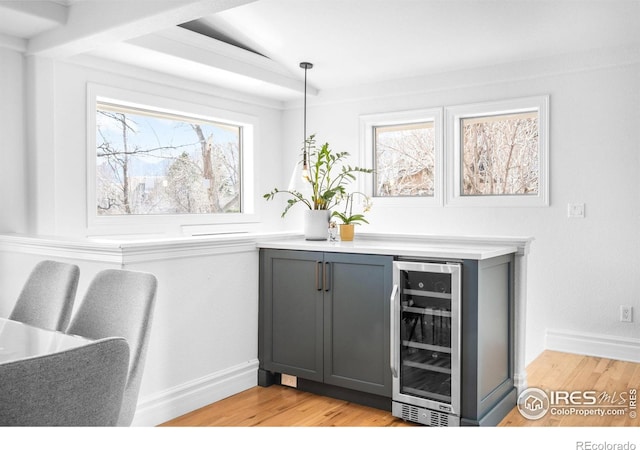 3380 Longwood Ave, Boulder, CO 80305 - bar featuring light wood-type flooring, wine cooler, bar area, and baseboards