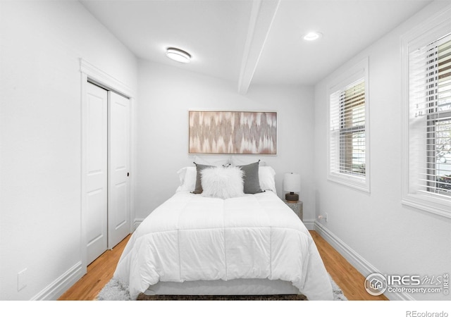 3380 Longwood Ave, Boulder, CO 80305 - bedroom featuring a closet, beamed ceiling, baseboards, and wood finished floors