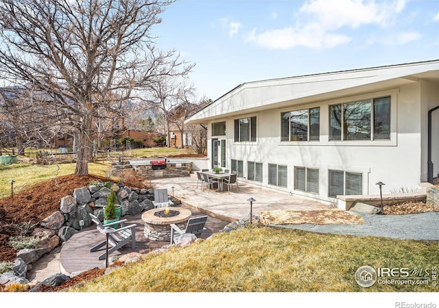 3380 Longwood Ave, Boulder, CO 80305 - back of property featuring stucco siding, a fire pit, a lawn, and a patio