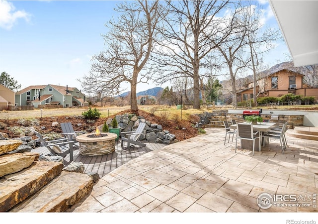 3380 Longwood Ave, Boulder, CO 80305 - view of patio with outdoor dining space, a mountain view, and an outdoor fire pit
