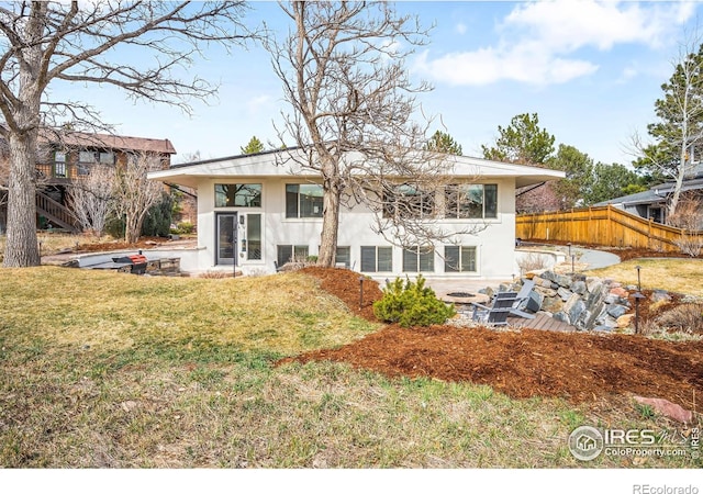 3380 Longwood Ave, Boulder, CO 80305 - back of property with stucco siding, a lawn, a patio area, and fence