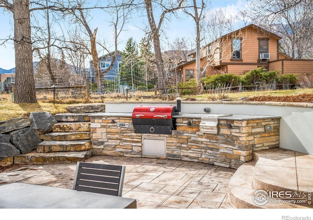 3380 Longwood Ave, Boulder, CO 80305 - view of patio with area for grilling, exterior kitchen, and fence