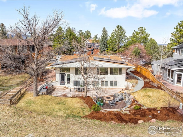 3380 Longwood Ave, Boulder, CO 80305 - rear view of property with solar panels, a lawn, french doors, stucco siding, and a patio