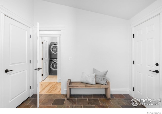 3380 Longwood Ave, Boulder, CO 80305 - corridor featuring stacked washer / dryer, stone tile floors, and baseboards