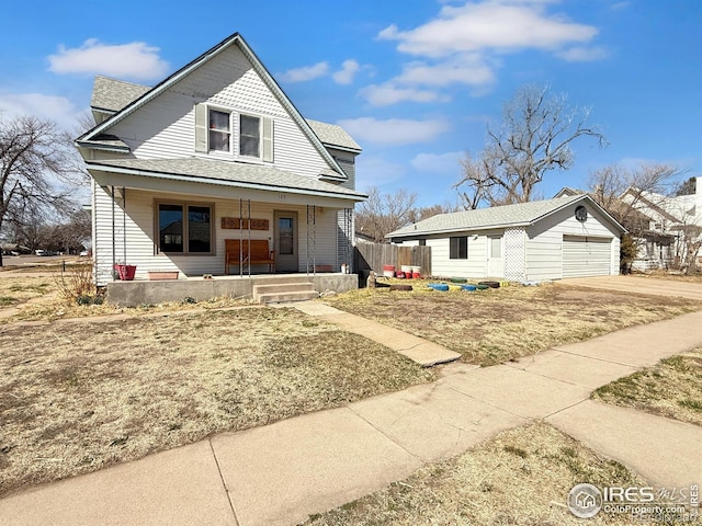 105 N Logan Ave, Haxtun, CO 80731 - view of front of property featuring a porch, an outbuilding, concrete driveway, and a shingled roof