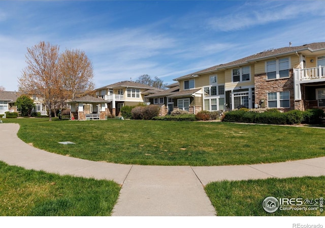 view of home's community featuring a lawn and a residential view