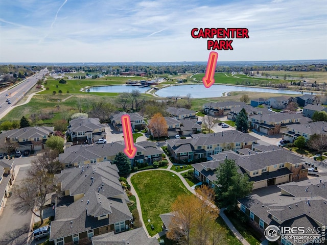 birds eye view of property with a residential view and a water view