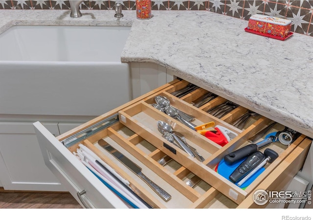details with a sink and wood finished floors