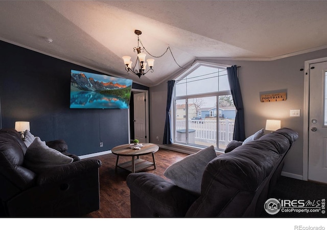 603 Lark Ln, Sterling, CO 80751 - living area with vaulted ceiling, a chandelier, dark wood-type flooring, baseboards, and crown molding