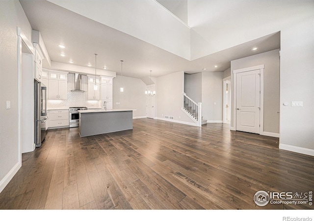 4300 Ardglass Ln, Timnath, CO 80547 - unfurnished living room featuring a chandelier, dark wood-style floors, stairway, baseboards, and recessed lighting