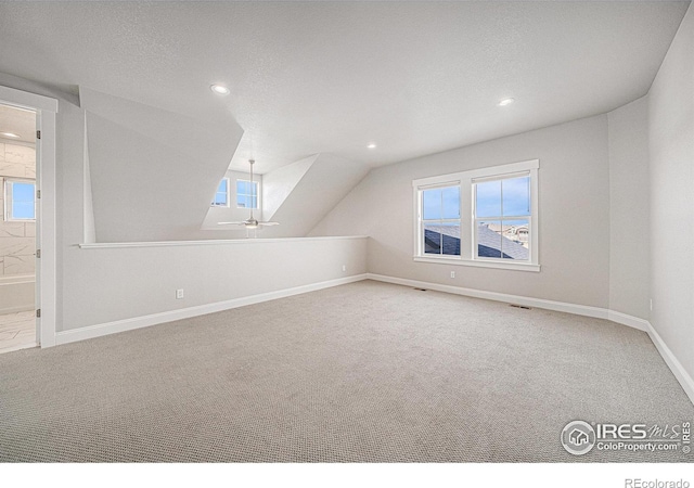 4300 Ardglass Ln, Timnath, CO 80547 - additional living space featuring carpet flooring, recessed lighting, baseboards, vaulted ceiling, and a textured ceiling