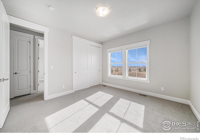 4300 Ardglass Ln, Timnath, CO 80547 - unfurnished bedroom featuring carpet flooring, baseboards, and a closet
