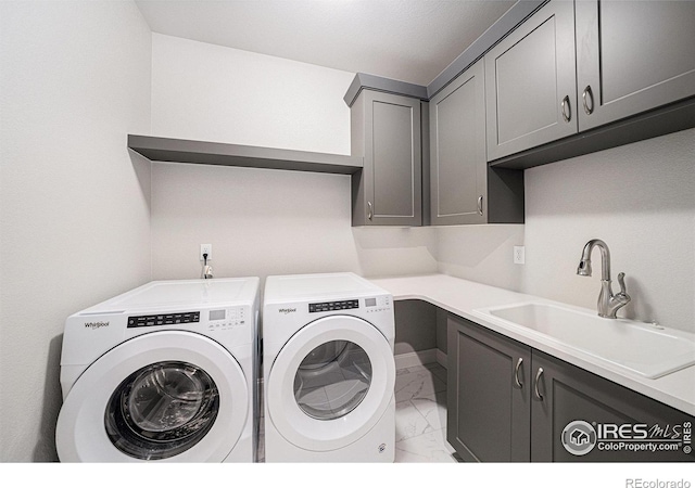 4300 Ardglass Ln, Timnath, CO 80547 - laundry room with cabinet space, light marble finish floors, and washer and clothes dryer