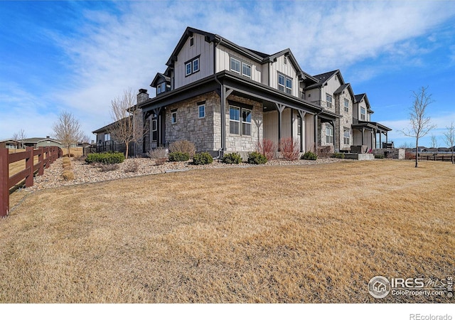 4300 Ardglass Ln, Timnath, CO 80547 - view of property exterior with board and batten siding, stone siding, a porch, and a chimney