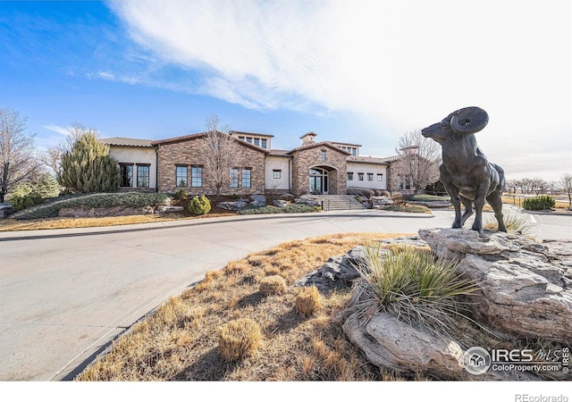 4300 Ardglass Ln, Timnath, CO 80547 - view of front of home with stucco siding, a tile roof, and stone siding