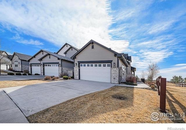 4300 Ardglass Ln, Timnath, CO 80547 - view of front of home featuring stone siding, concrete driveway, and an attached garage