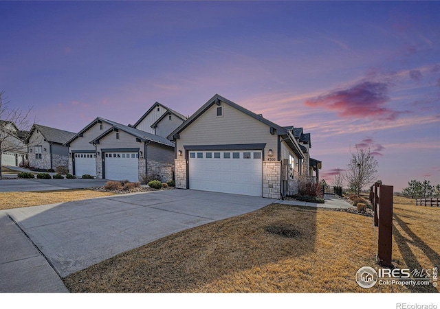 4300 Ardglass Ln, Timnath, CO 80547 - view of front of house featuring stone siding, a garage, concrete driveway, and a front lawn