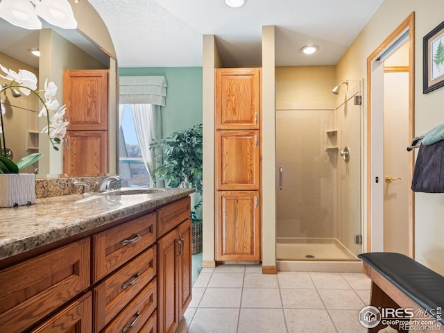 43 Scott Dr S, Broomfield, CO 80020 - bathroom featuring a shower stall, vanity, and tile patterned floors