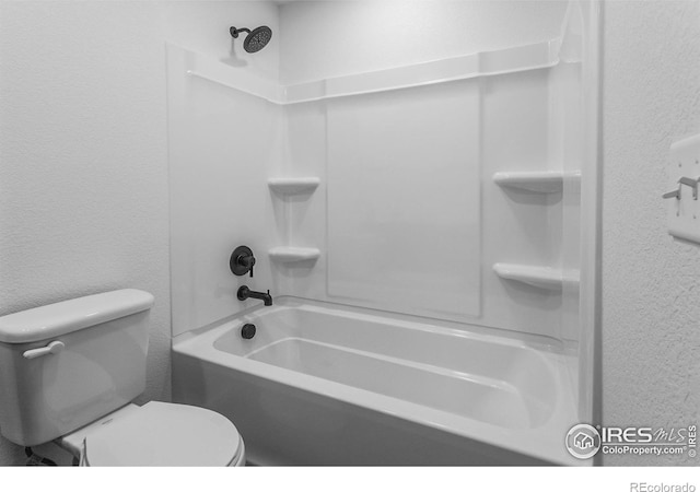 full bath featuring a textured wall, shower / bath combination, and toilet