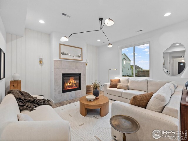 2412 Cottongrass Ave, Loveland, CO 80538 - living area featuring recessed lighting, visible vents, wood finished floors, and a tile fireplace