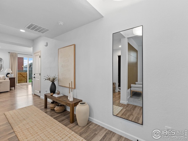 2412 Cottongrass Ave, Loveland, CO 80538 - hall with stairs, visible vents, wood finished floors, and baseboards