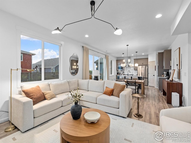 2412 Cottongrass Ave, Loveland, CO 80538 - living area featuring a chandelier, light wood finished floors, and recessed lighting