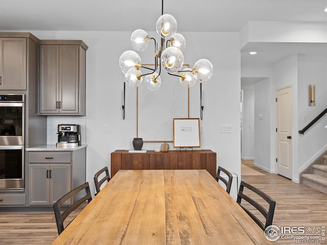 2412 Cottongrass Ave, Loveland, CO 80538 - dining space with an inviting chandelier, baseboards, stairs, and light wood-type flooring