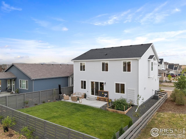 2412 Cottongrass Ave, Loveland, CO 80538 - back of house with a garden, an outdoor hangout area, a fenced backyard, a lawn, and a patio area