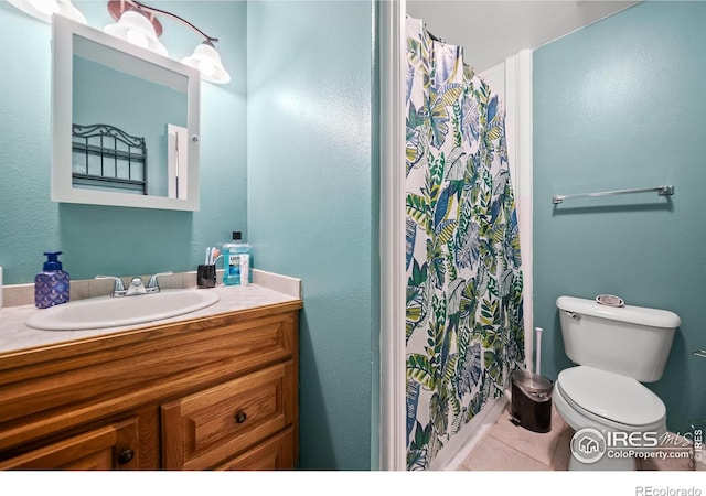 bathroom with tile patterned flooring, curtained shower, vanity, and toilet