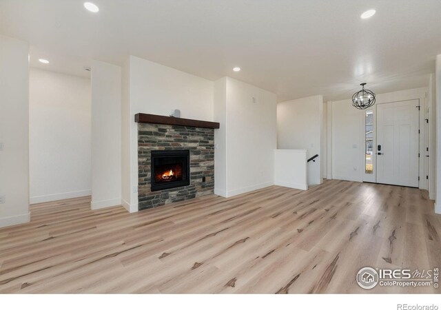unfurnished living room with baseboards, light wood-style flooring, and recessed lighting
