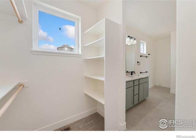 bathroom with vanity and baseboards