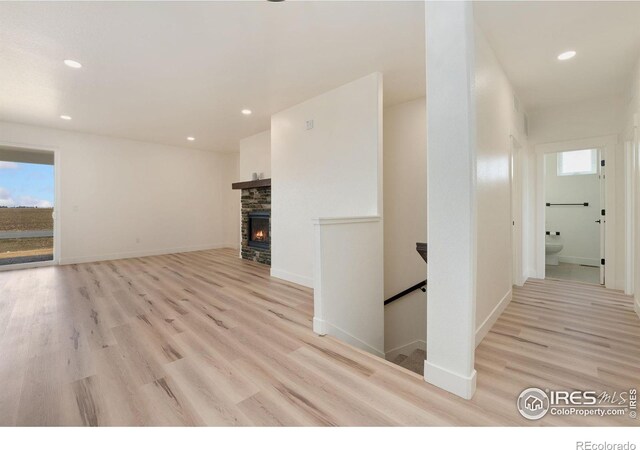 interior space featuring baseboards, a healthy amount of sunlight, recessed lighting, and light wood finished floors