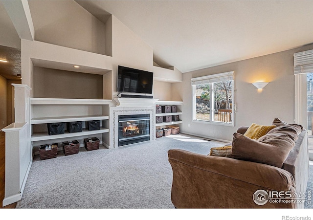 2409 Denby Ct, Fort Collins, CO 80526 - living area featuring a tiled fireplace, carpet, lofted ceiling, and built in features