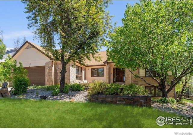 2409 Denby Ct, Fort Collins, CO 80526 - view of front facade with brick siding, a front lawn, and a garage