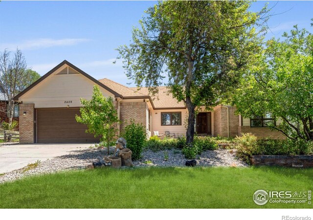 2409 Denby Ct, Fort Collins, CO 80526 - view of front of property featuring an attached garage, brick siding, concrete driveway, and a front yard
