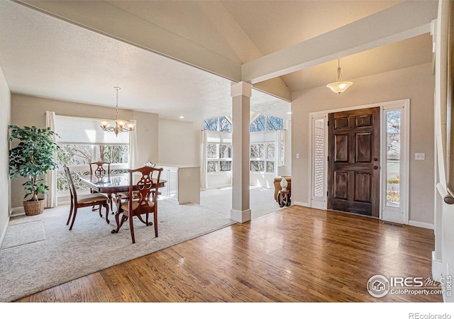 2409 Denby Ct, Fort Collins, CO 80526 - foyer with wood finished floors, a chandelier, baseboards, and decorative columns