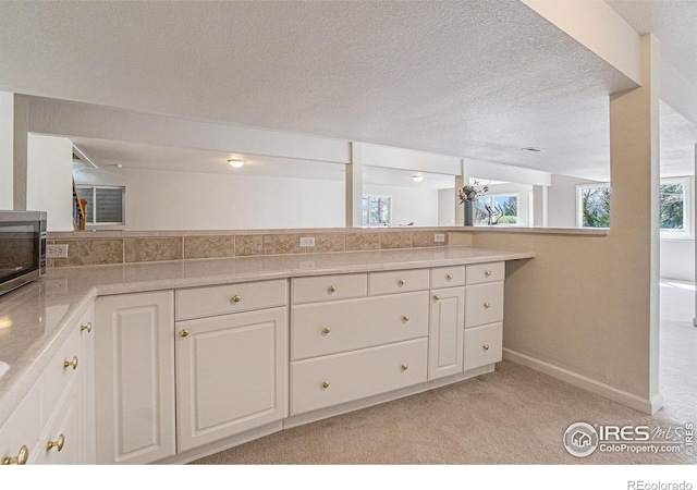2409 Denby Ct, Fort Collins, CO 80526 - bathroom with baseboards, vanity, and a textured ceiling