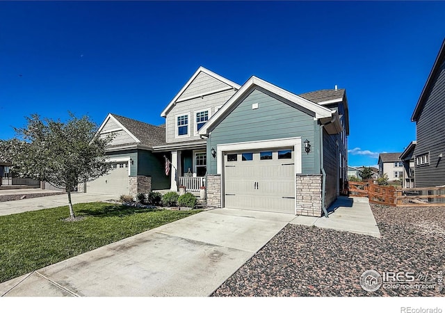 view of front facade featuring stone siding, a garage, and driveway