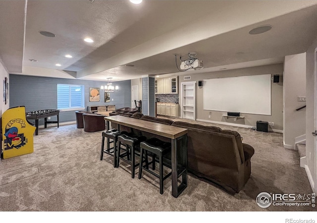 carpeted cinema room with baseboards, a chandelier, and recessed lighting