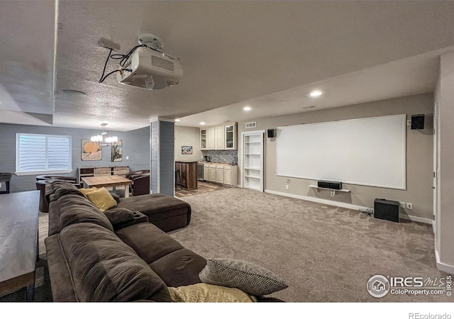 carpeted cinema room with a chandelier, recessed lighting, baseboards, and a textured ceiling